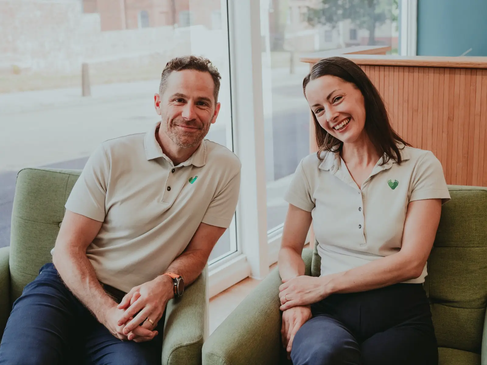 James and Fran Morgan sitting in the green armchairs by the street window of the Exeter clinic lounge